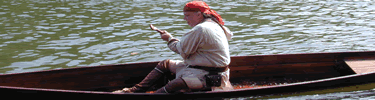 trapper in canoe - reenactor at arkansas post